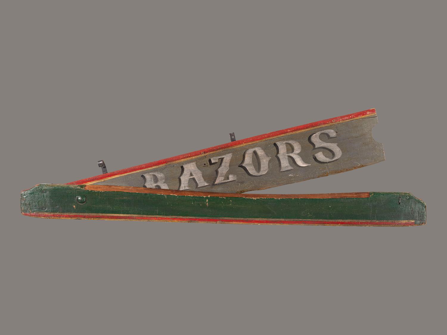 A Polychrome Painted Pine Razor Barber Shop Sign