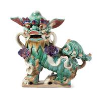 A Chinese Green, Aubergine and Yellow Glazed Pottery Fu Lion-Form Roof Tile Height 17 inches. — MING DYNASTY (1368-1644)