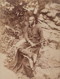 HILLERS, John K. (1843-1925), photographer. Photograph of an Osage warrior holding a tomahawk. Okmulgee, Indian Territory, 1875.