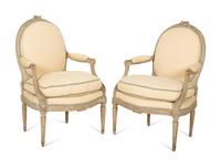 A Set of Four Louis XVI Grey-Painted and Parcel Gilt Fauteuils