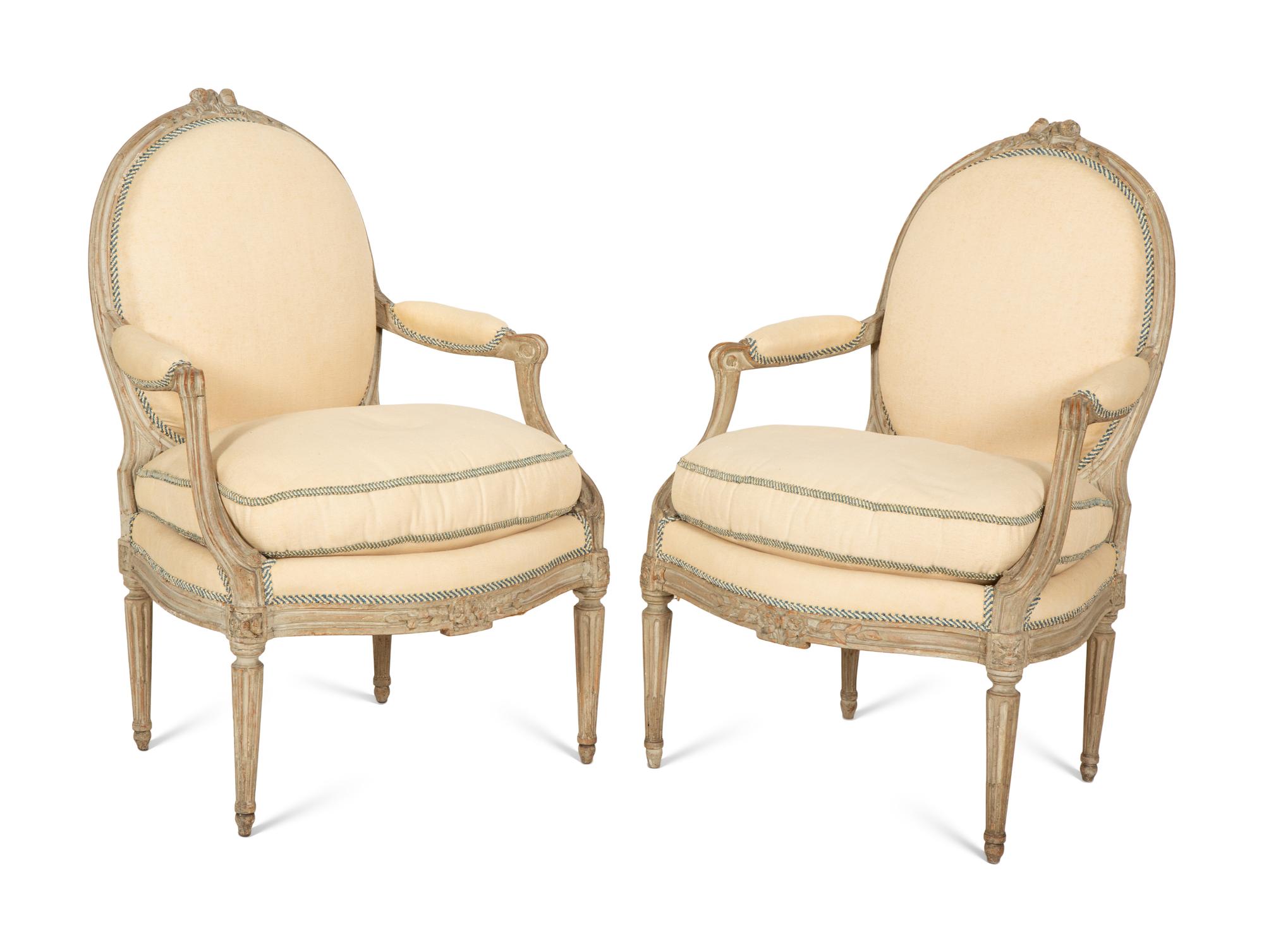 A Set of Four Louis XVI Grey-Painted and Parcel Gilt Fauteuils