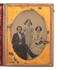 [EARLY PHOTOGRAPHY]. Whole plate ambrotype of a family of three.