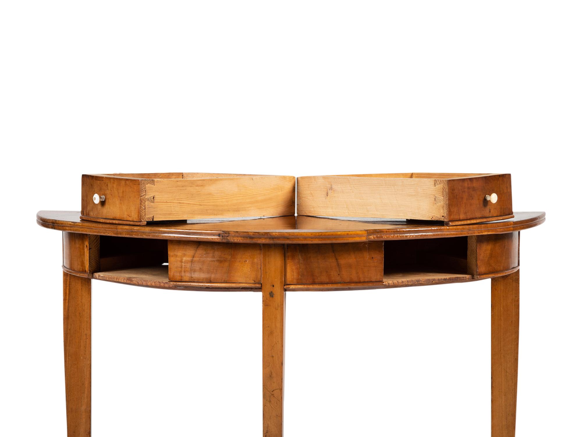 A Biedermeier Figured Birch Demilune Table