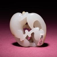 A Chinese Russet and Jade 'Double Badger' Pendant, 18th/19th Century — 清中期 白玉帶皮如意雙歡佩