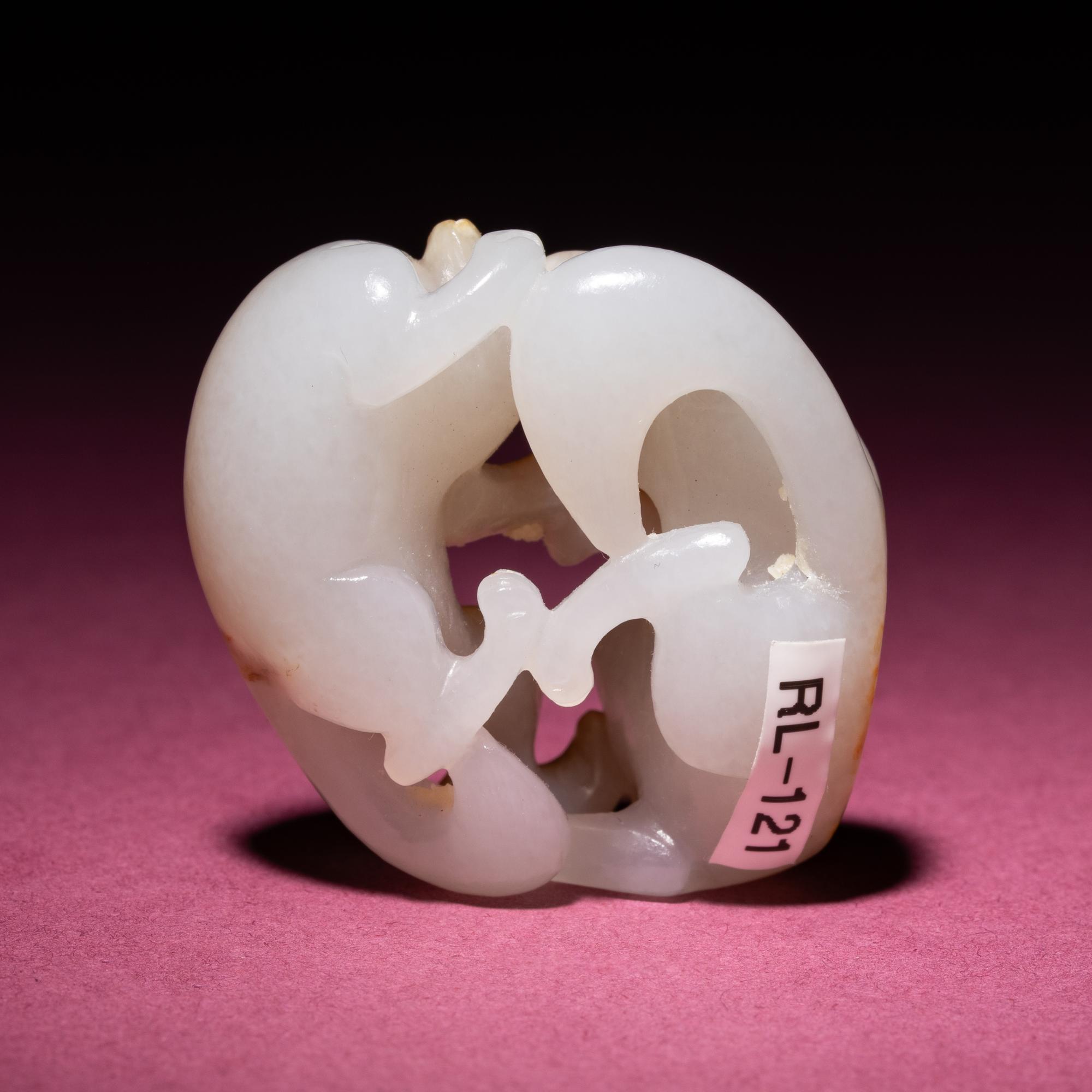 A Chinese Russet and Jade 'Double Badger' Pendant, 18th/19th Century — 清中期 白玉帶皮如意雙歡佩