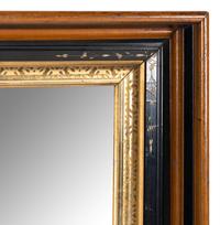 A Continental Walnut Parcel-Gilt and Ebonized Mirror
