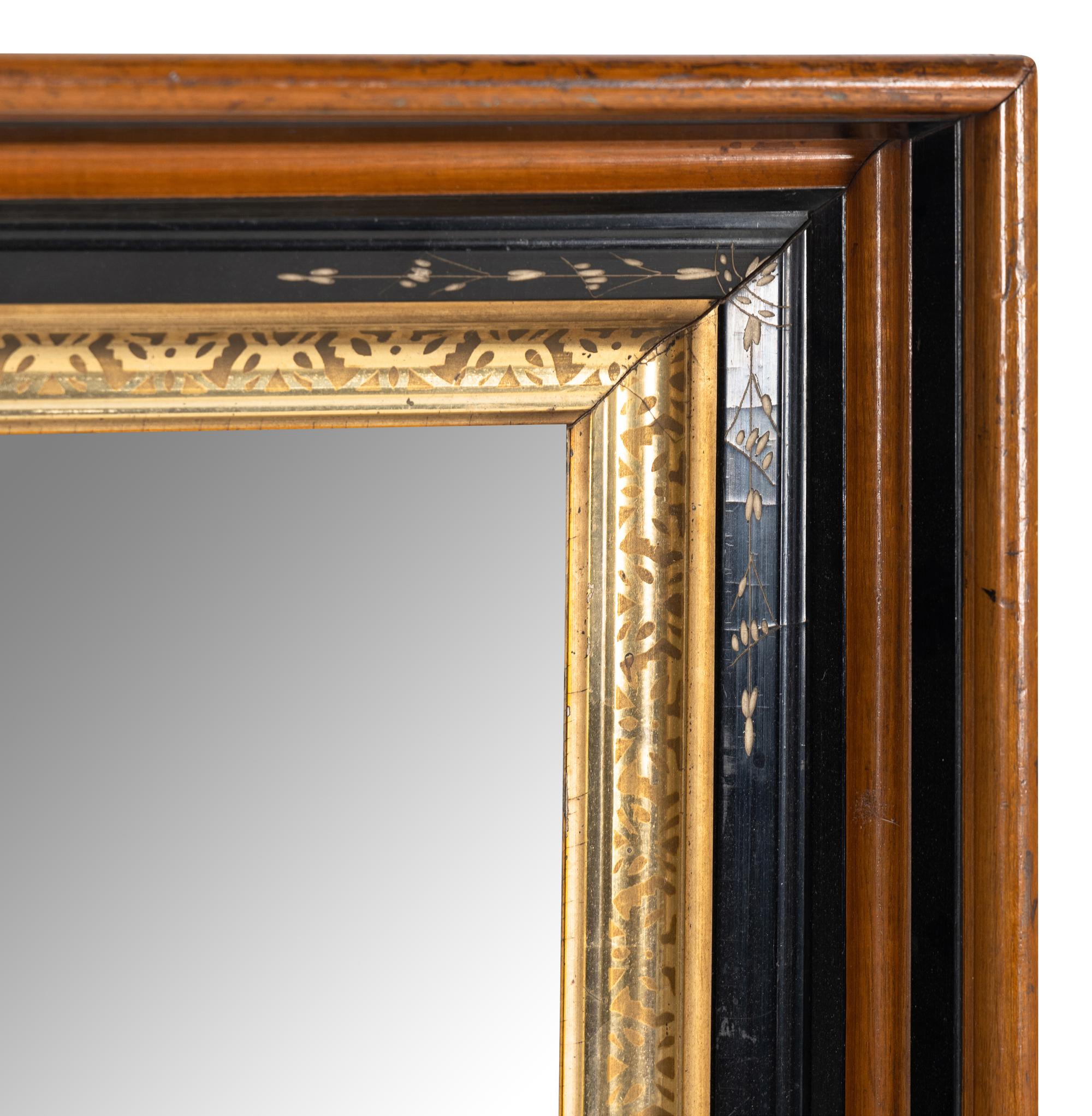 A Continental Walnut Parcel-Gilt and Ebonized Mirror