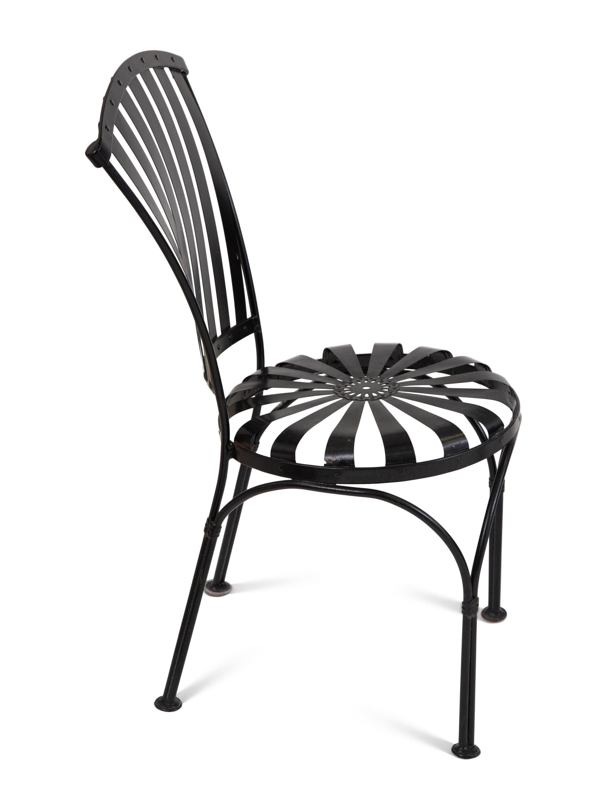 A Spring Steel Garden Table and Eight Chairs by Francois Carre