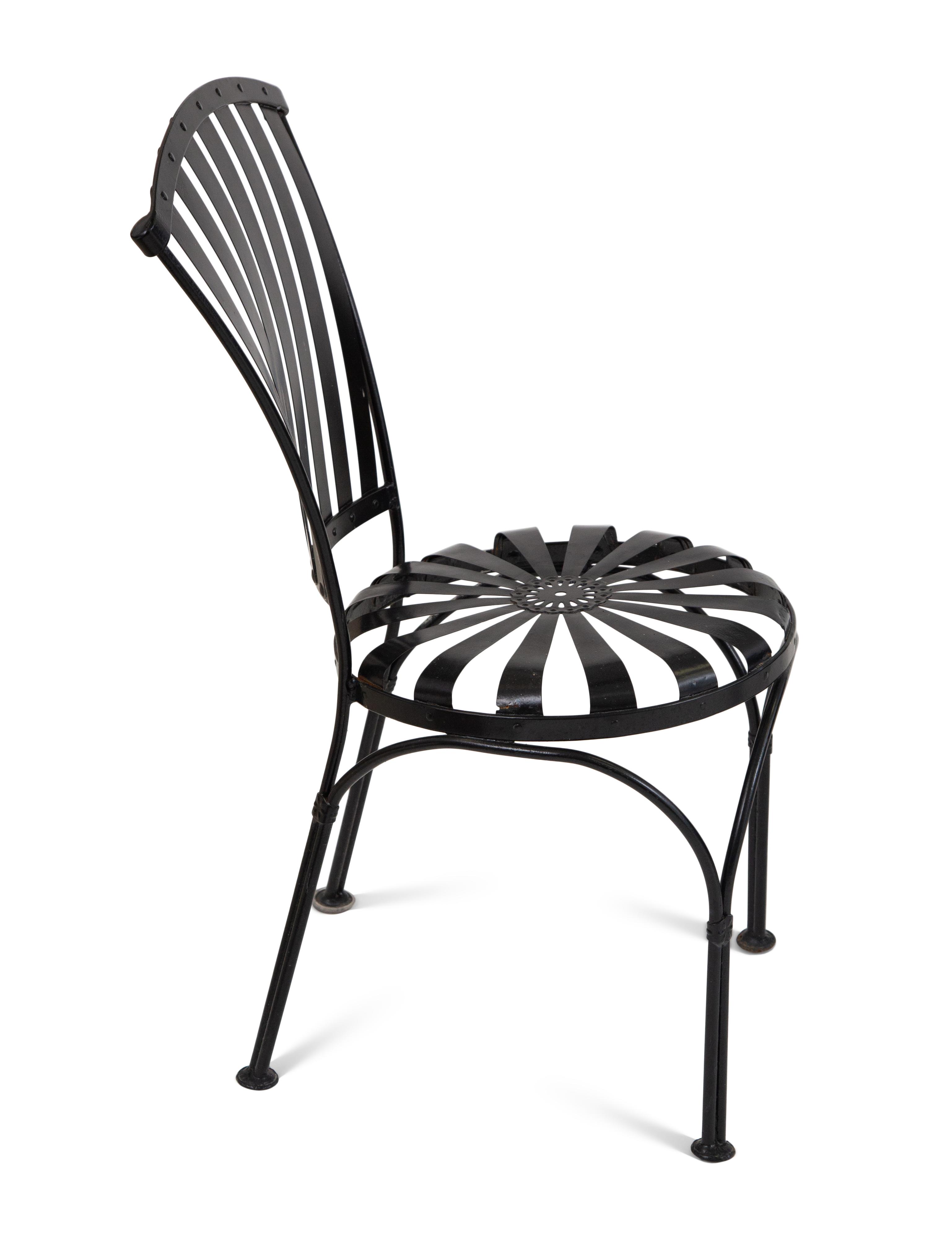 A Spring Steel Garden Table and Eight Chairs by Francois Carre