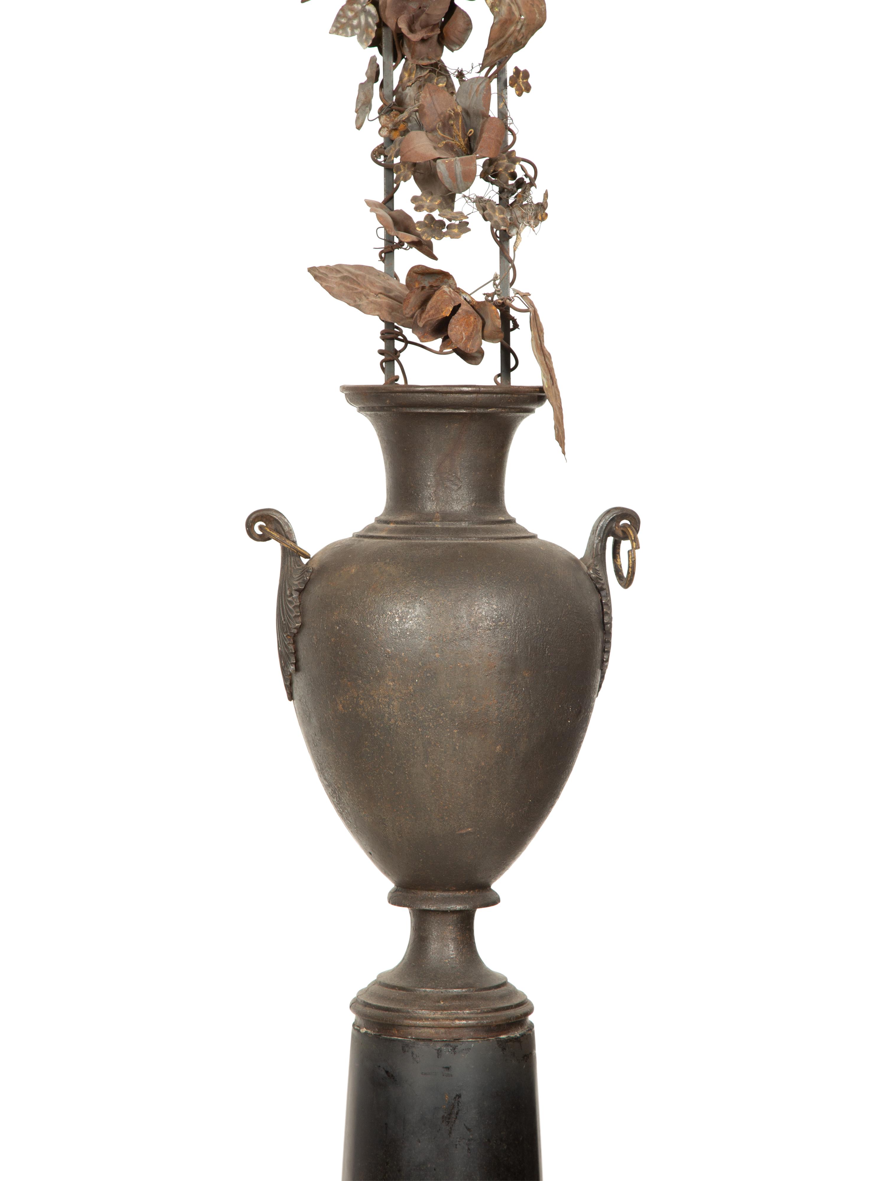 A Pair of French Bronze Urns with Tole Trellises of Floral Vines on Marble Pedestals
