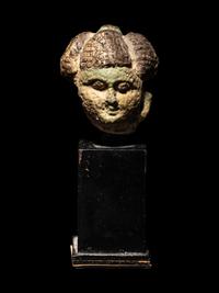 An Egyptian Faience Head of a Concubine