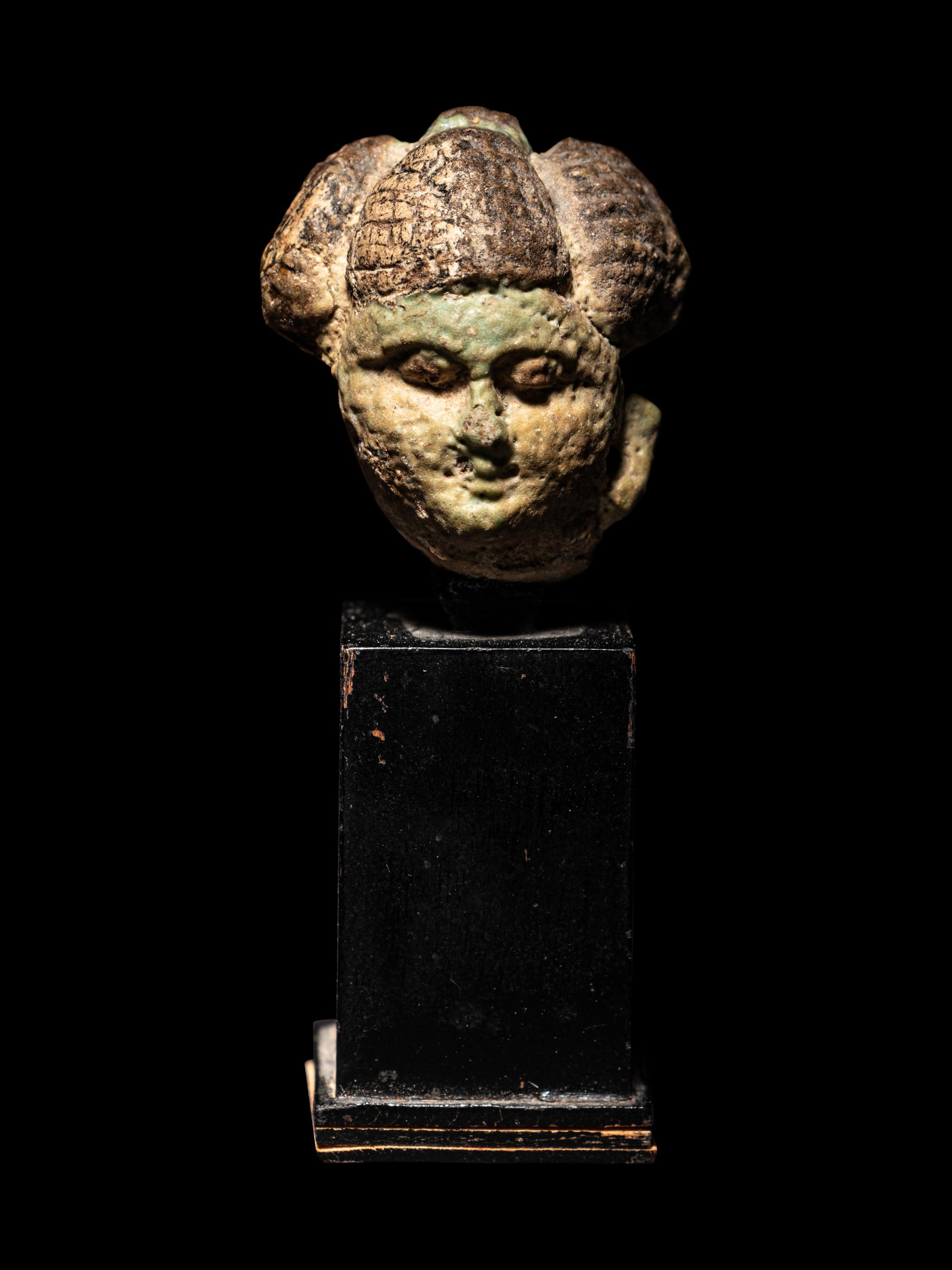An Egyptian Faience Head of a Concubine