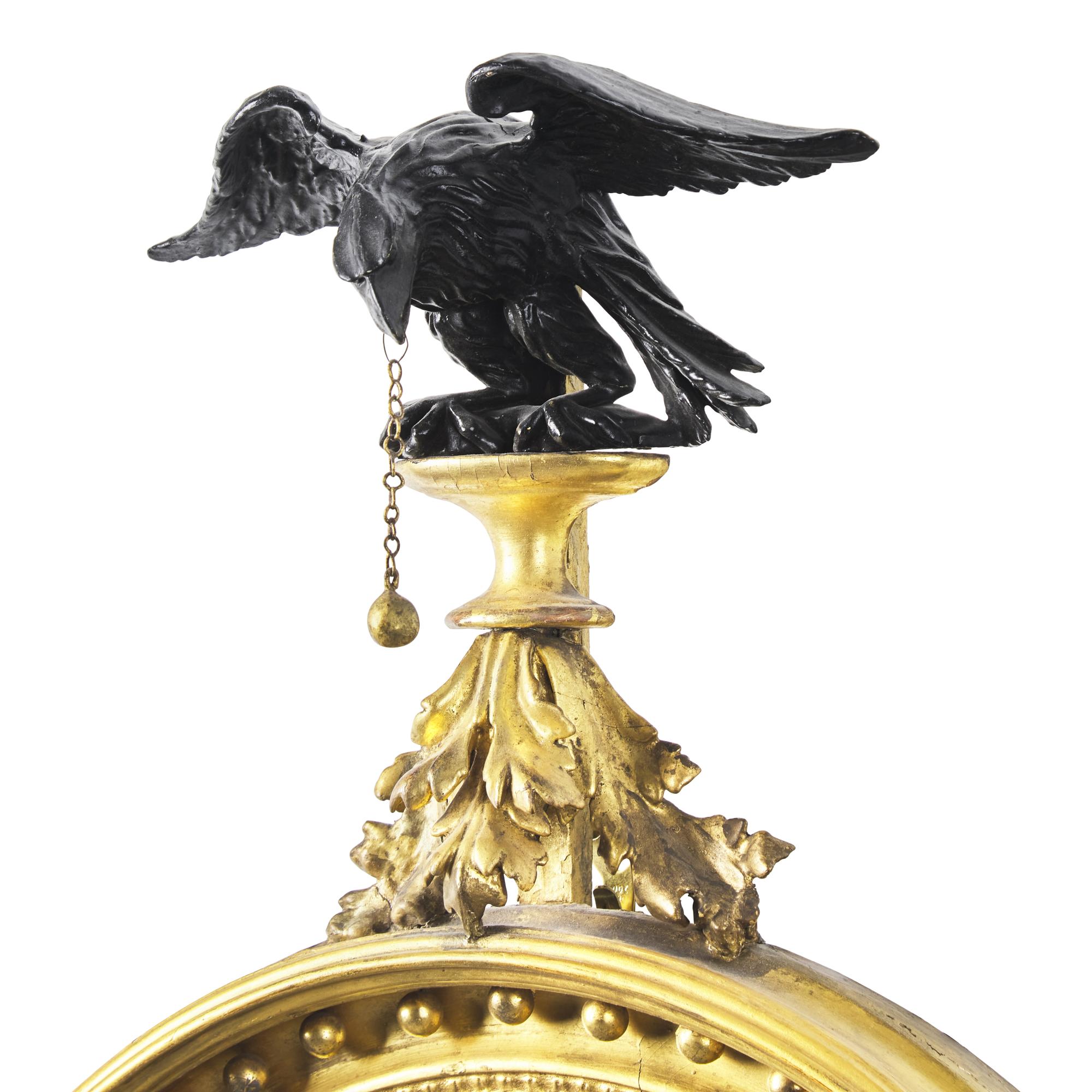 A Classical Carved, Gilt and Parcel Ebonized Two-Light Bull's Eye Girandole Mirror
