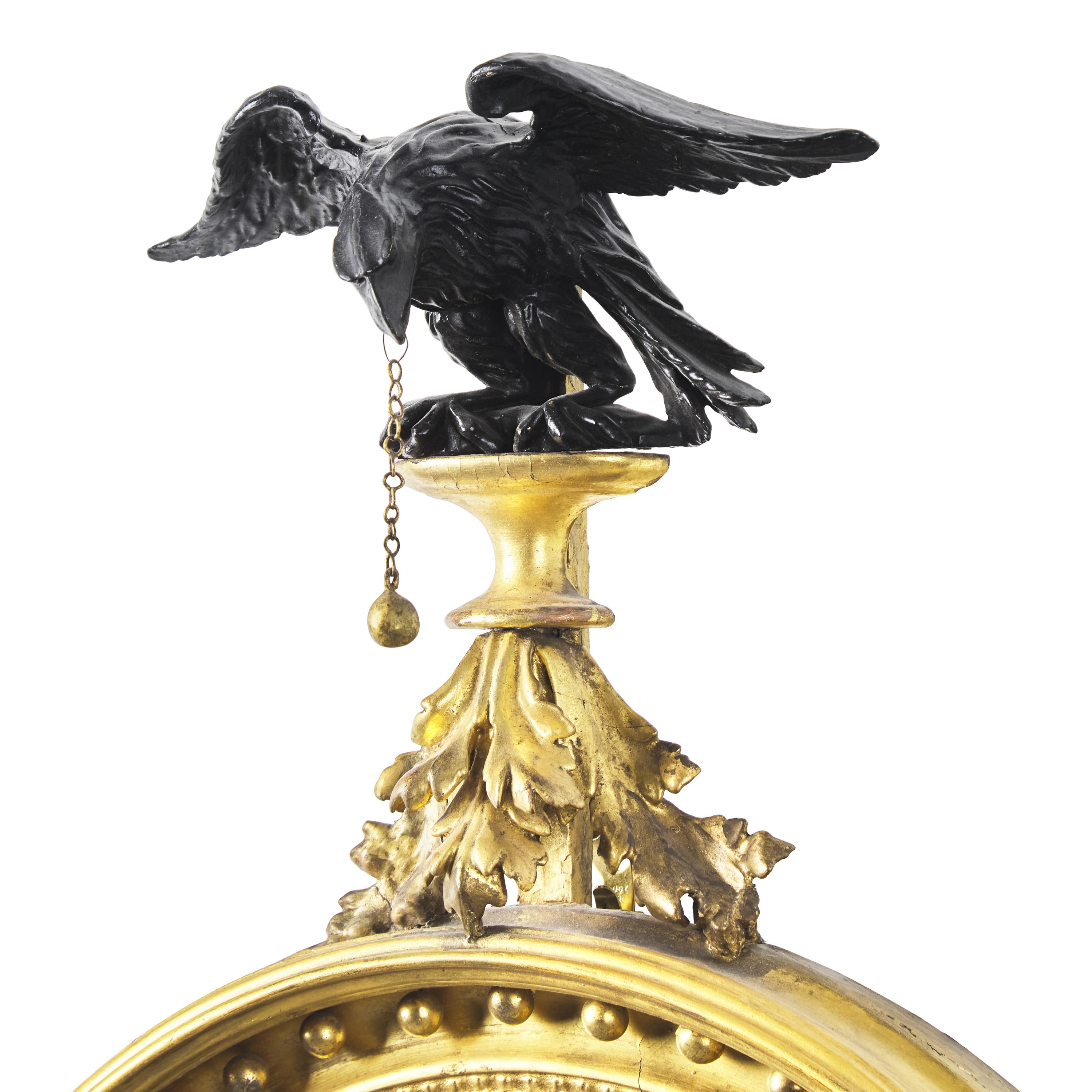A Classical Carved, Gilt and Parcel Ebonized Two-Light Bull's Eye Girandole Mirror