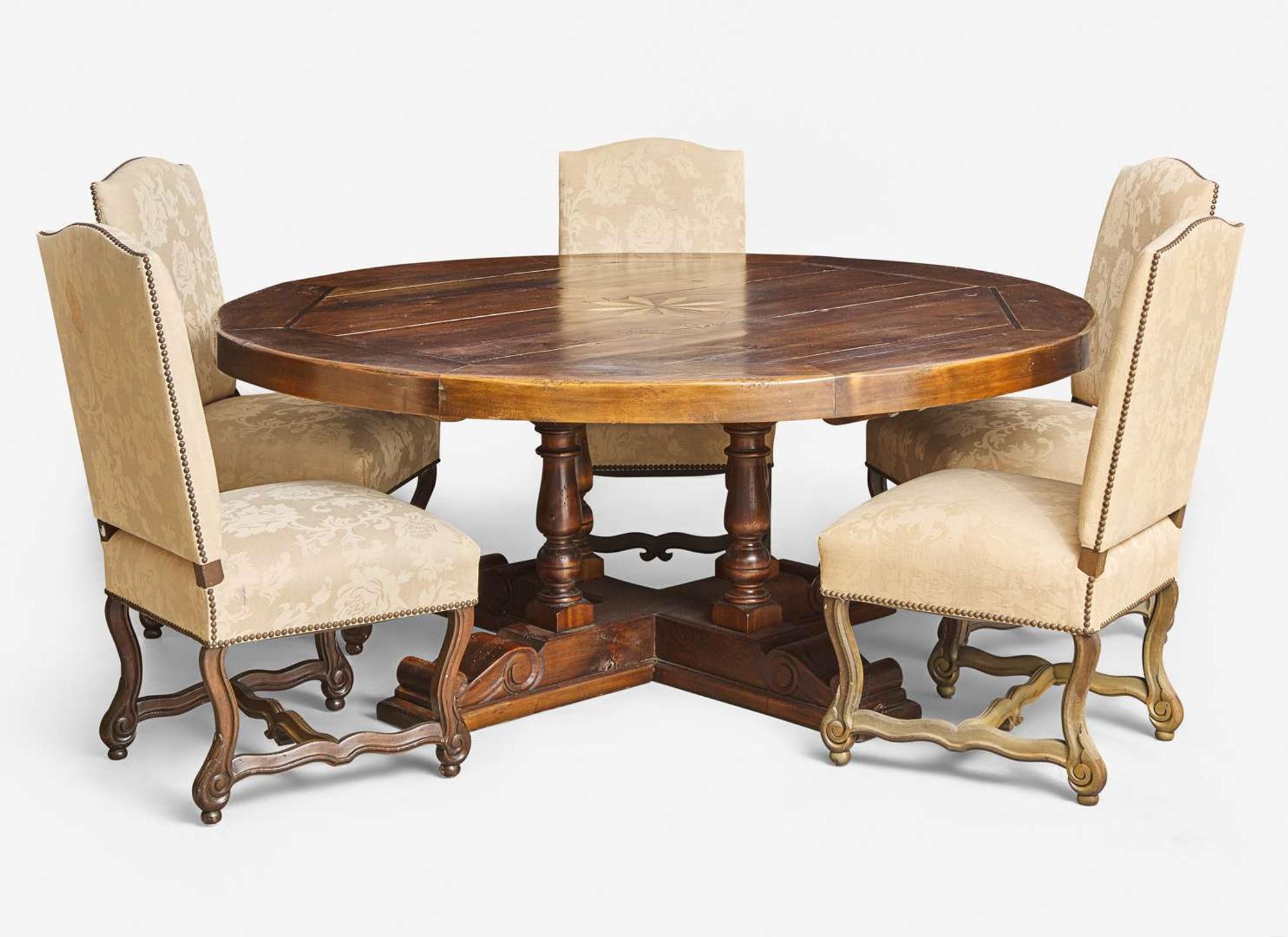 A Baroque style circular pine dining table together with a set of five Baroque style upholstered wood dining chairs, modern