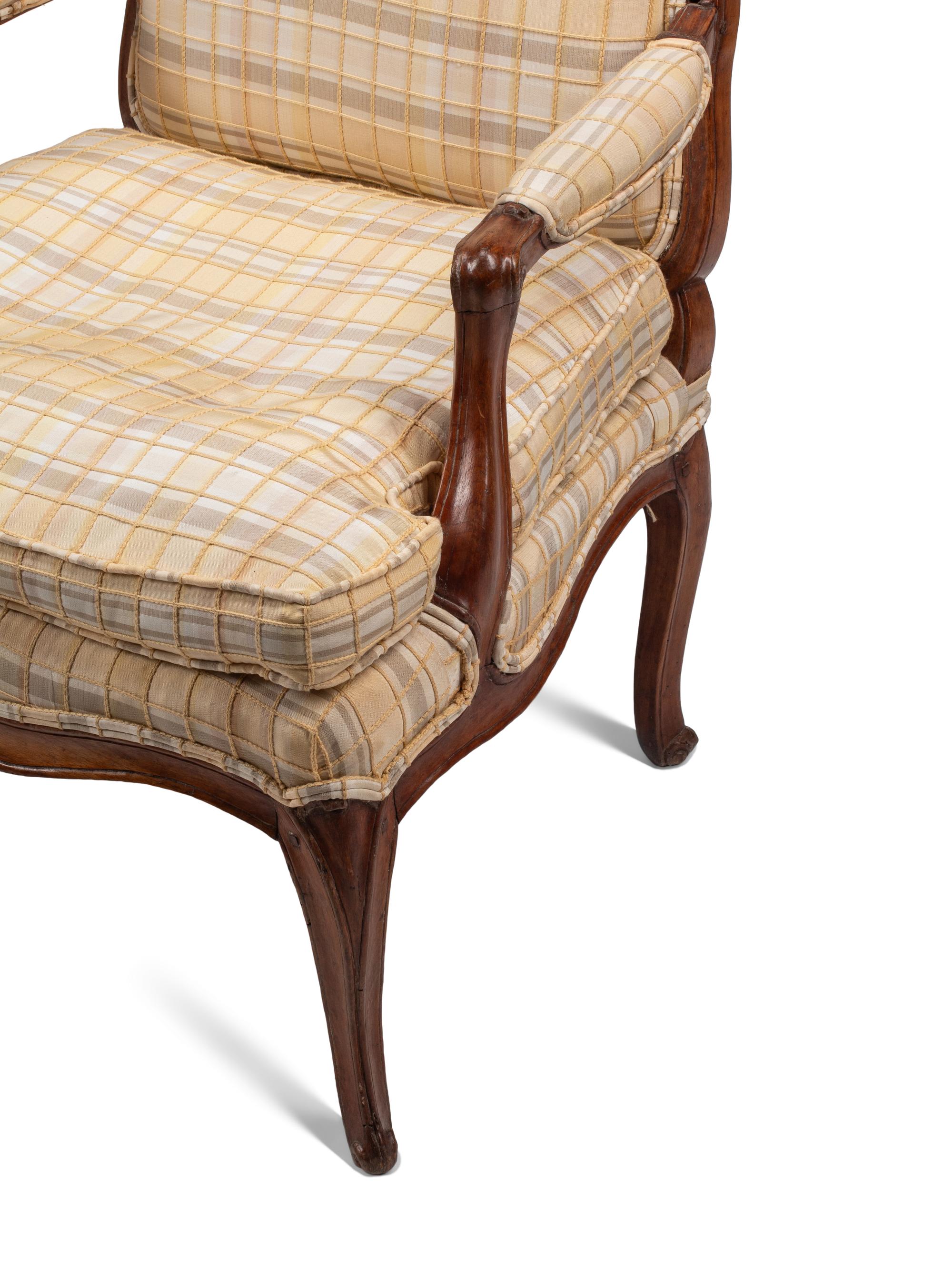 A Pair of Louis XV Provincial Walnut Fauteuils
