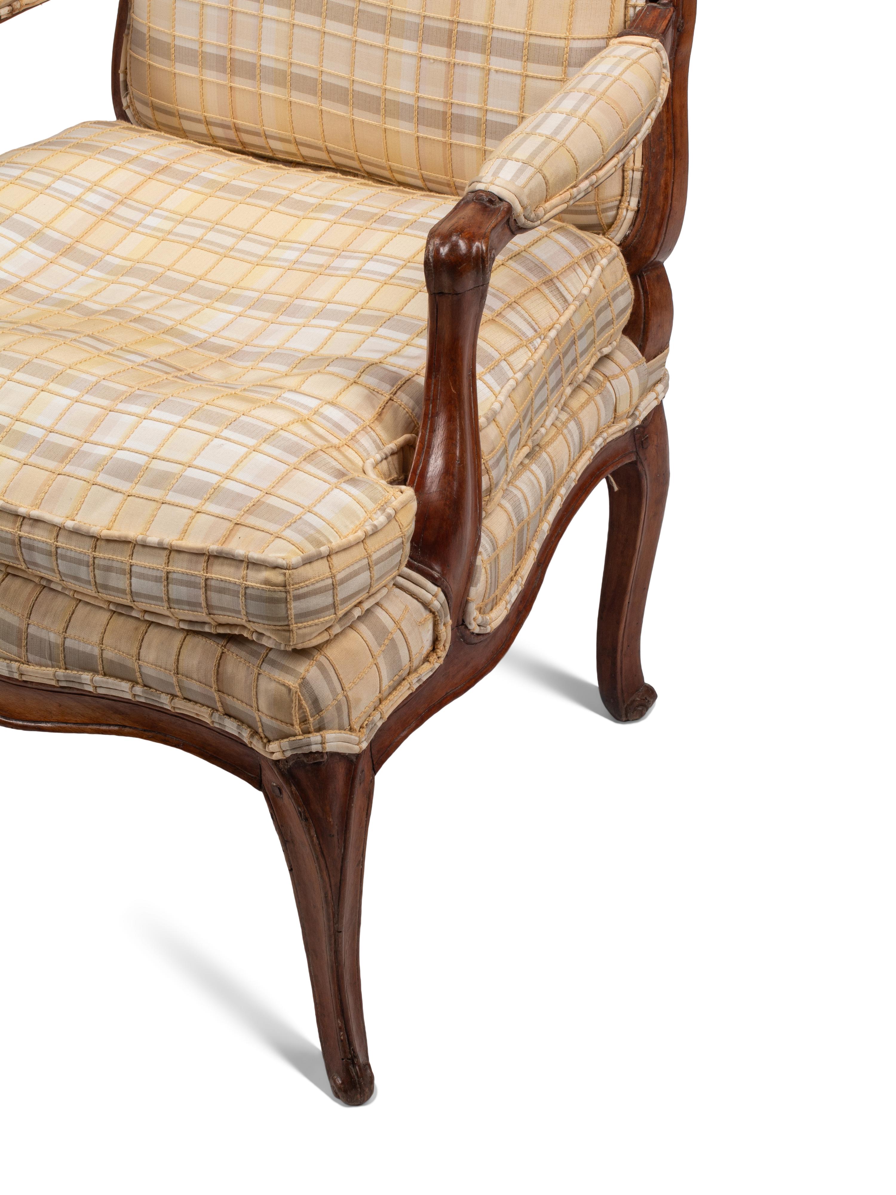 A Pair of Louis XV Provincial Walnut Fauteuils