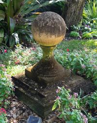 A Pair of Carved Stone Sphere Form Capitals on Pyramid Bases