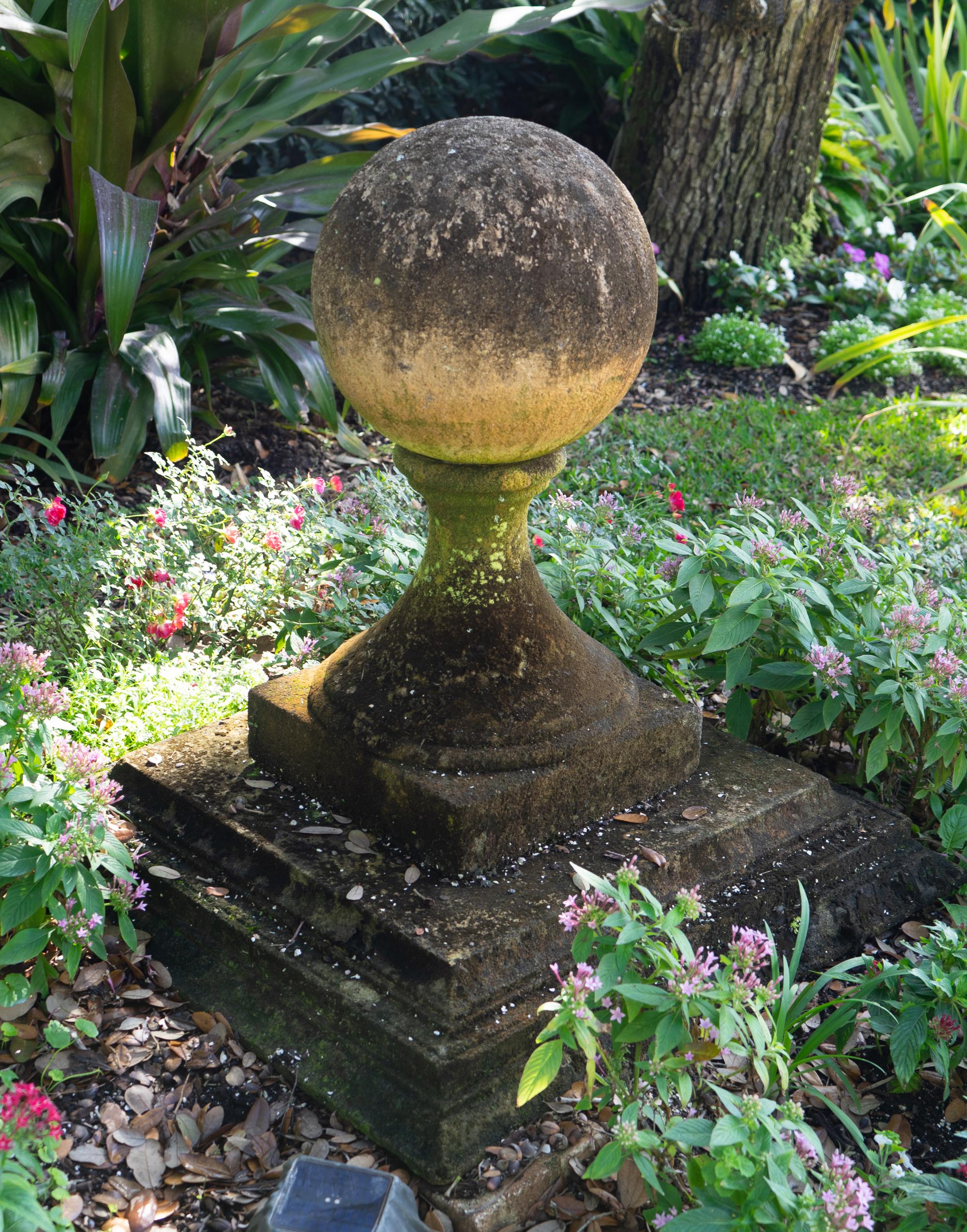 A Pair of Carved Stone Sphere Form Capitals on Pyramid Bases