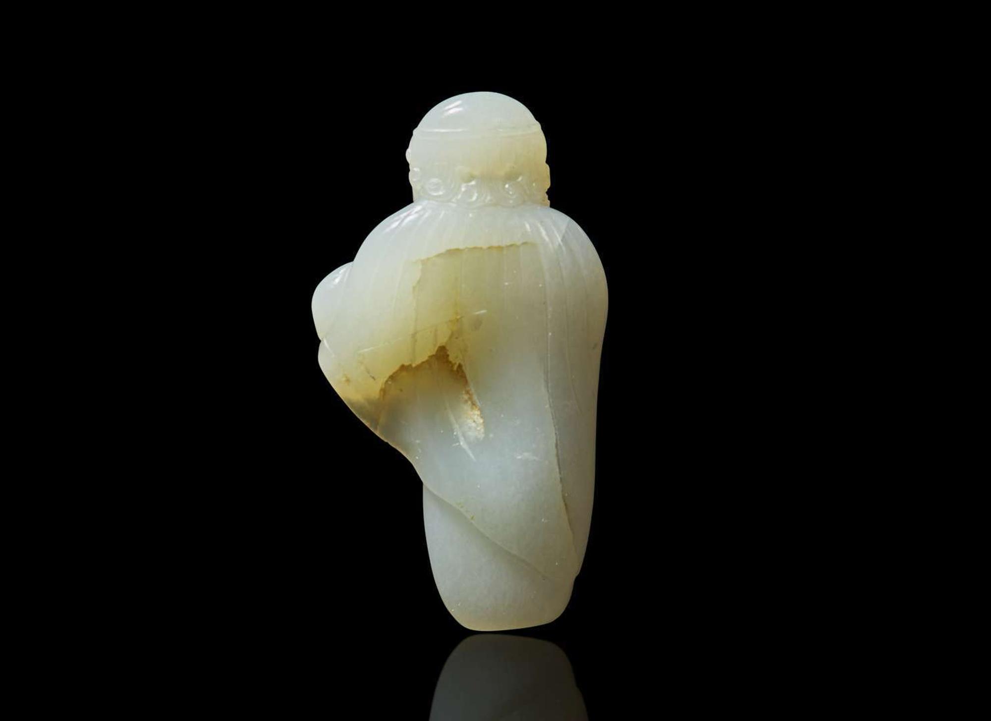 A small Chinese carved pale celadon jade figure of a foreigner 青白玉雕胡人