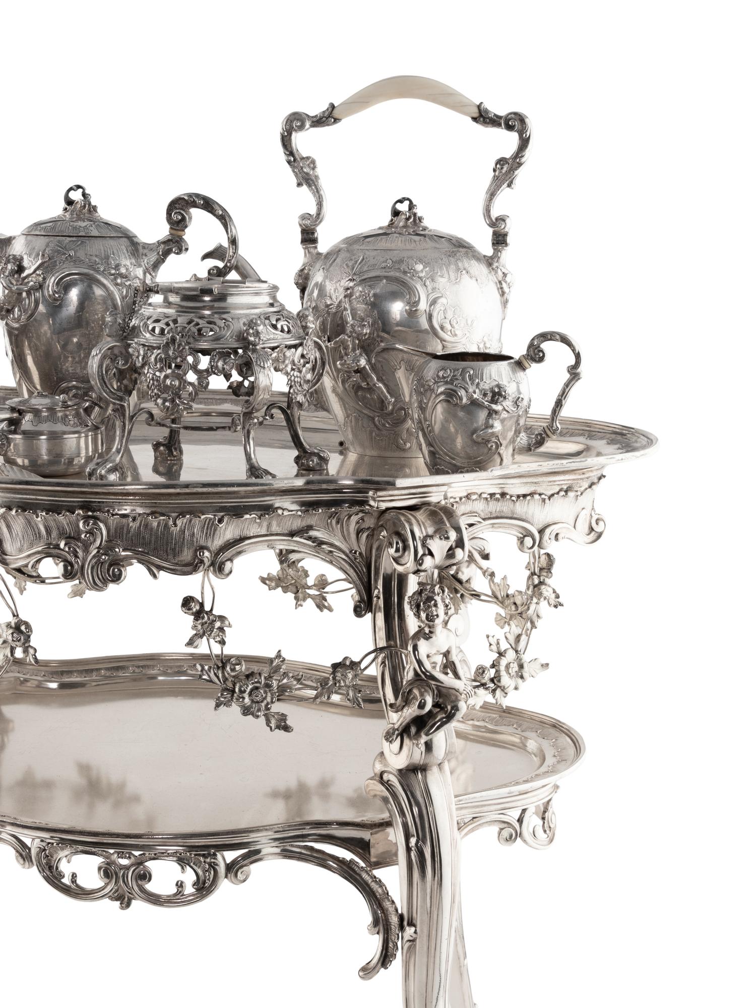 A Rare German Silver Two-Tier Tea Table with Matching Five-Piece Tea Service and Two Trays