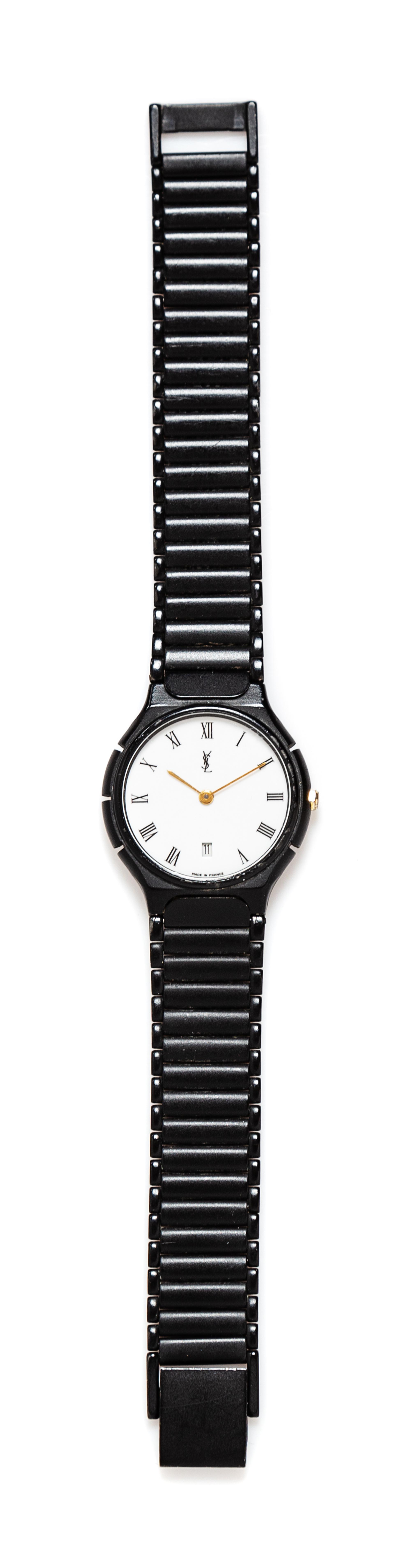 An Yves Saint Black Quartz Wristwatch, 7" L x .5" W; Face: 1" diameter.