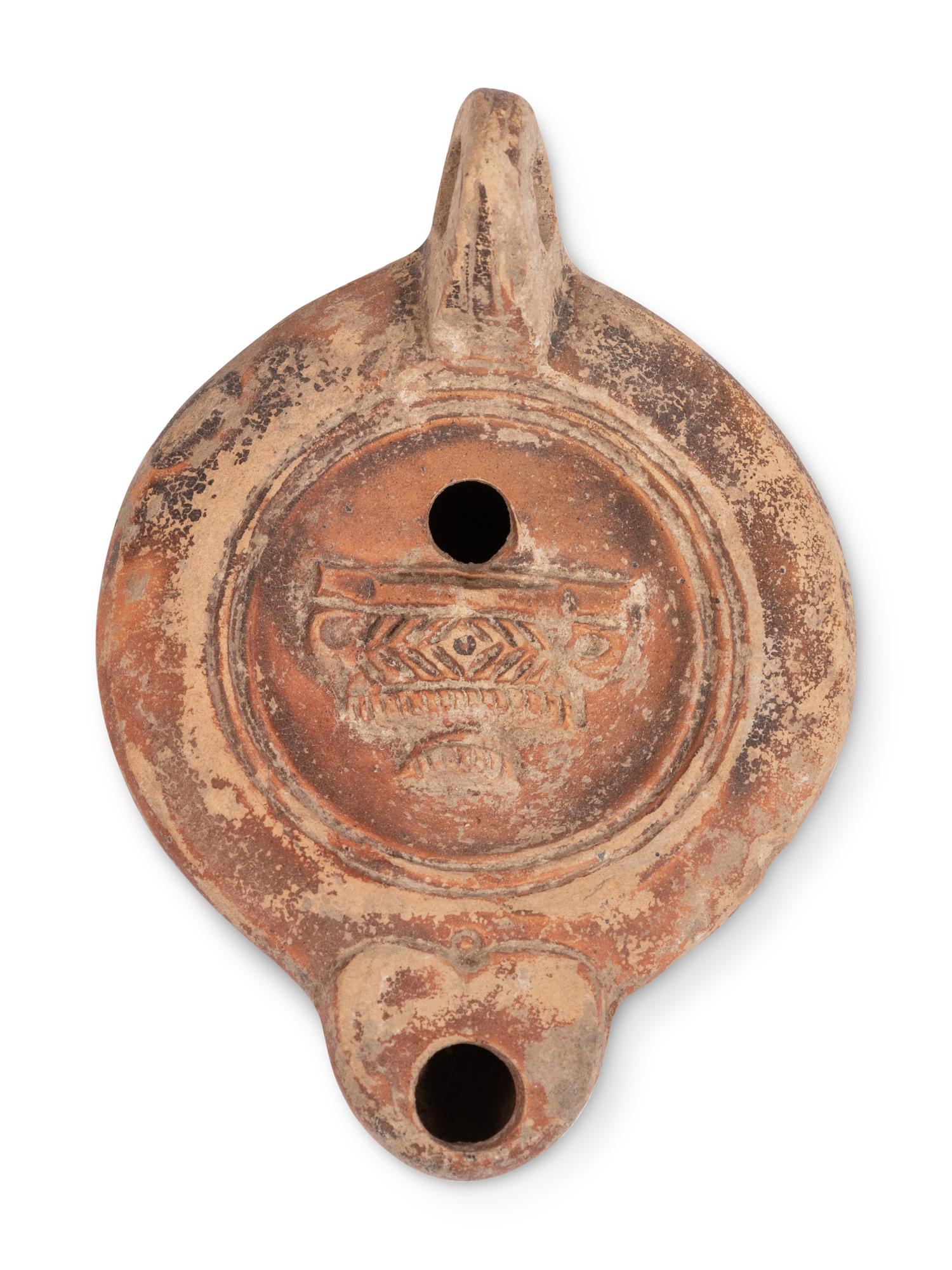 Ten Roman Terracotta Oil Lamps and a Holy Land Pottery Jug