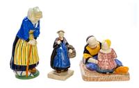 A Collection of Quimper Pottery Figures Height of first 11 3/4 inches.