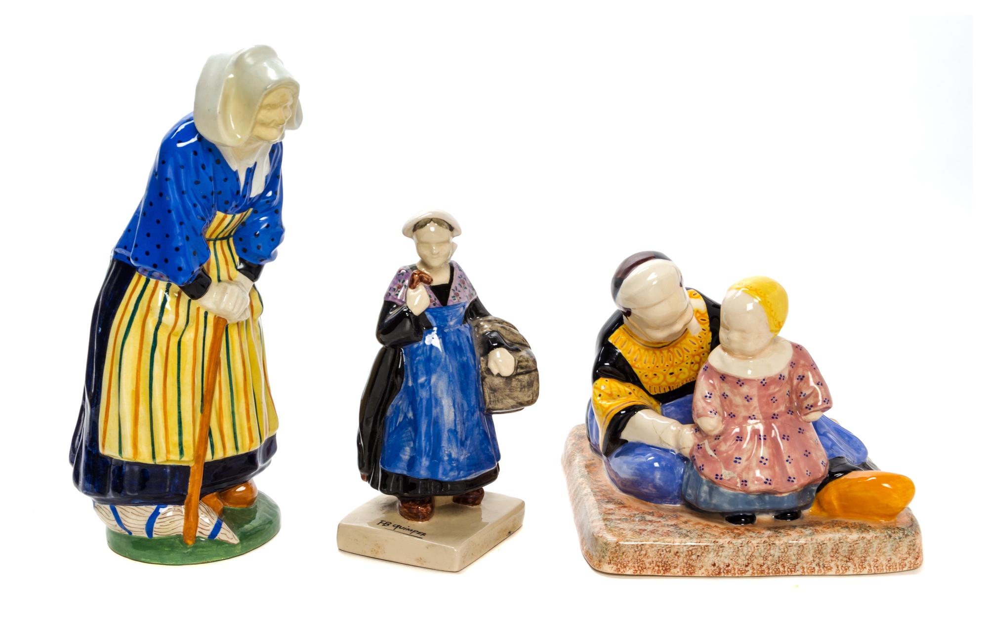 A Collection of Quimper Pottery Figures Height of first 11 3/4 inches.