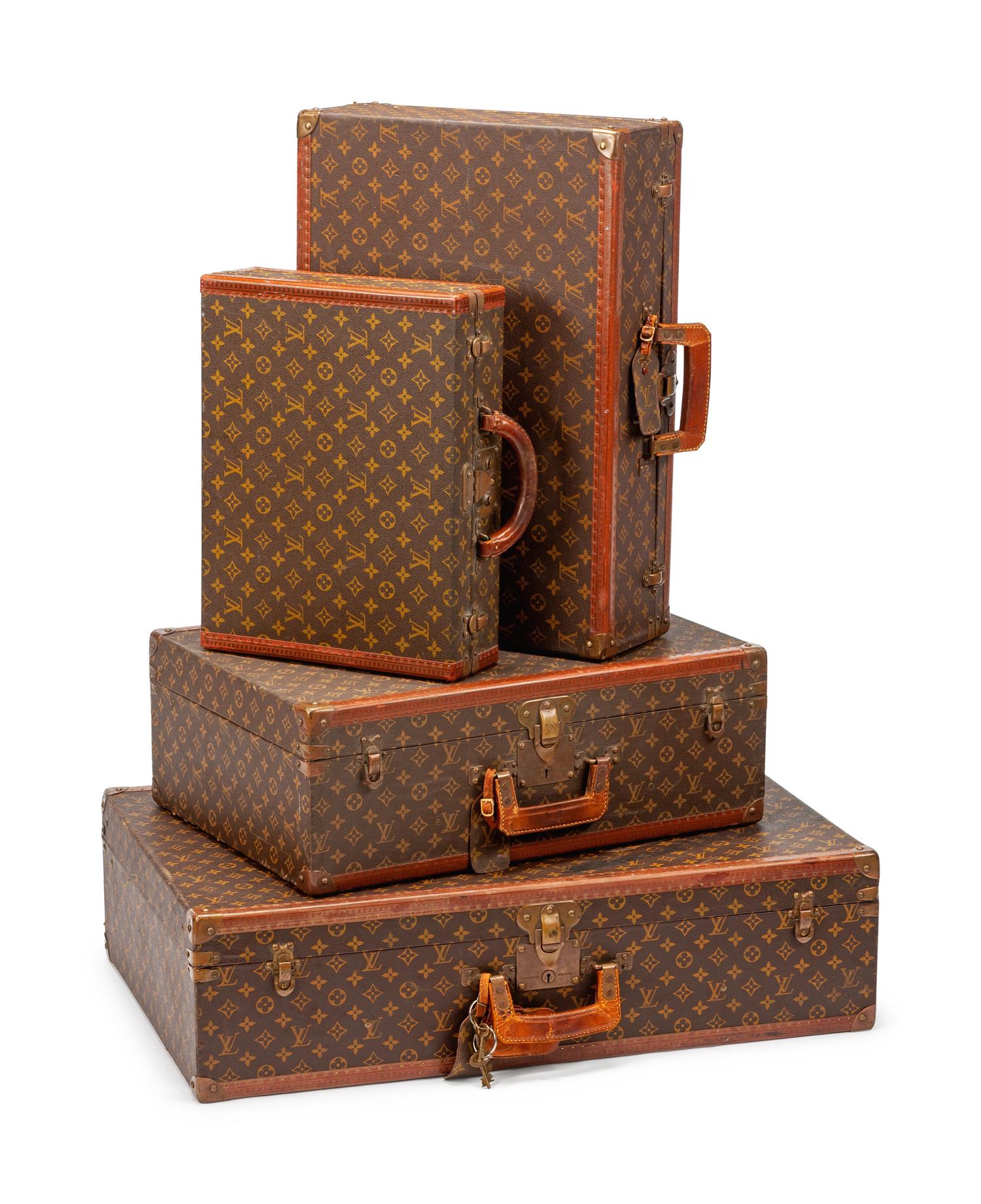 A Group of Four Louis Vuitton Hard-Sided Suitcases