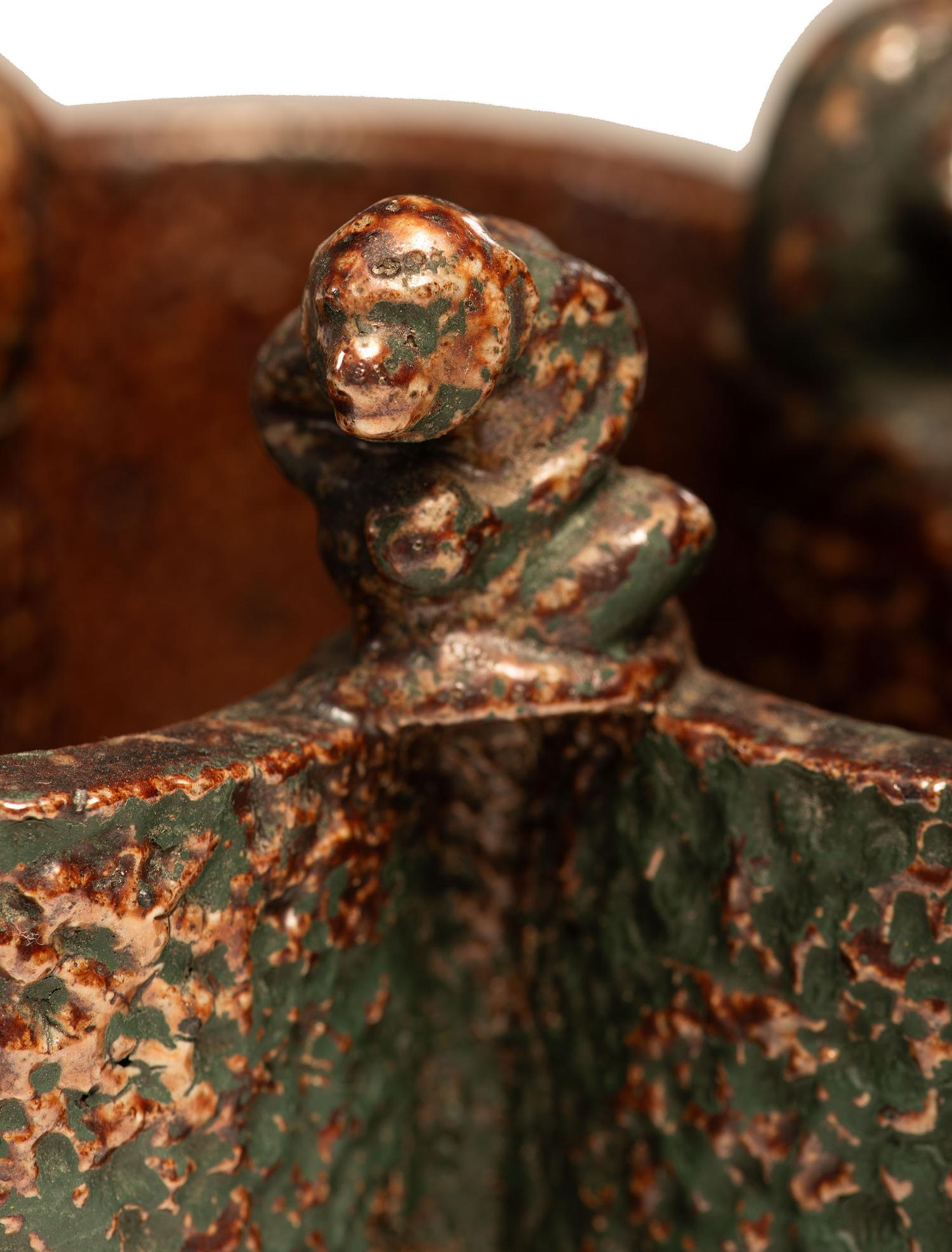 A Glazed Sewer Tile Trefoil Vase or Planter with Seated Monkeys