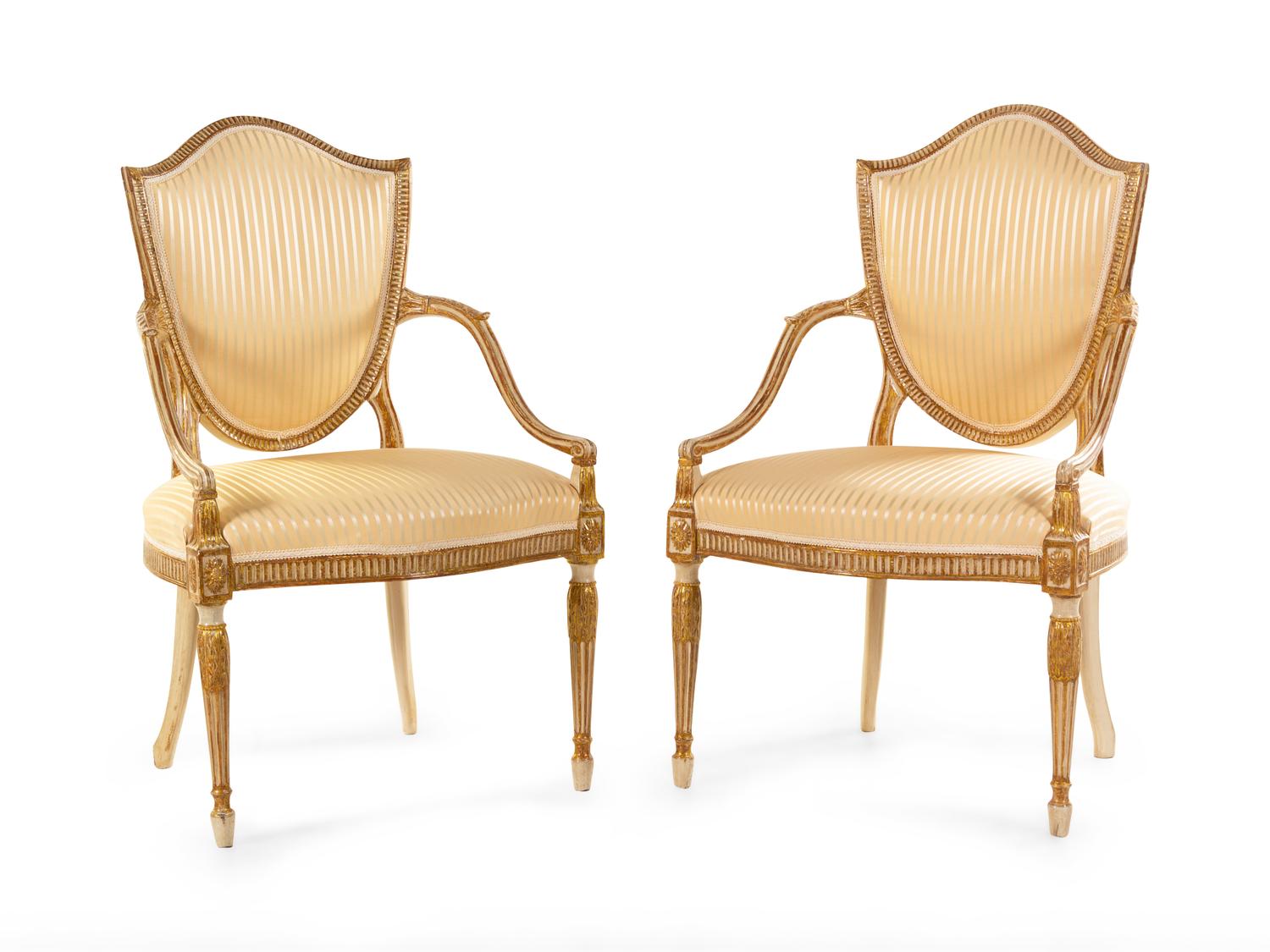 A Pair of George III Cream-Painted and Parcel Gilt Shield-Back Armchairs