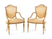 A Pair of George III Cream-Painted and Parcel Gilt Shield-Back Armchairs