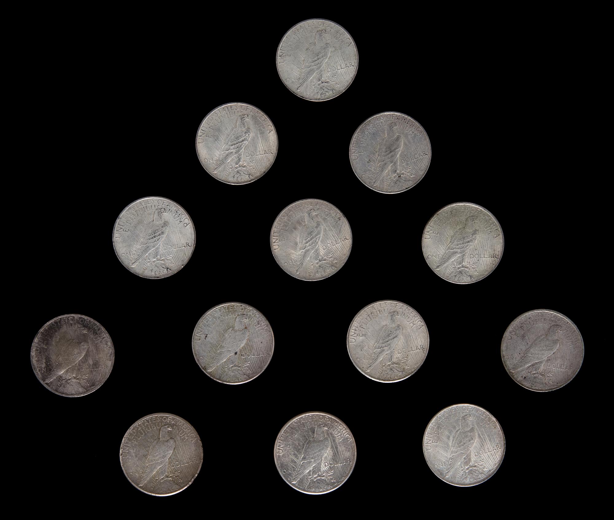 A Group of Thirteen United States Peace Silver Dollar Coins