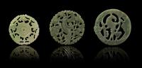 Three Pierce Carved Jade Circular Pendants Diameter of largest 2 1/2 inches.