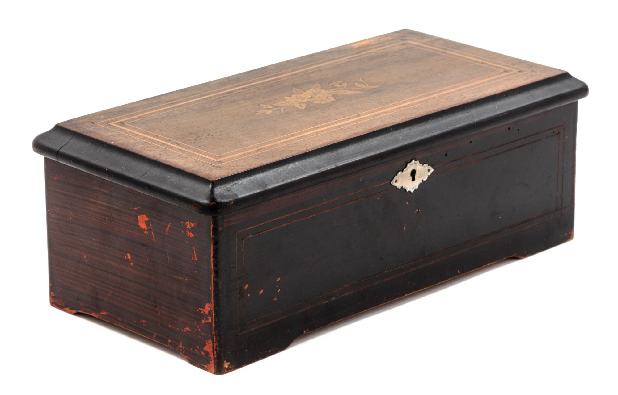 A Swiss Ebonized Music Box Height 5 x width 14 inches. — 19TH CENTURY