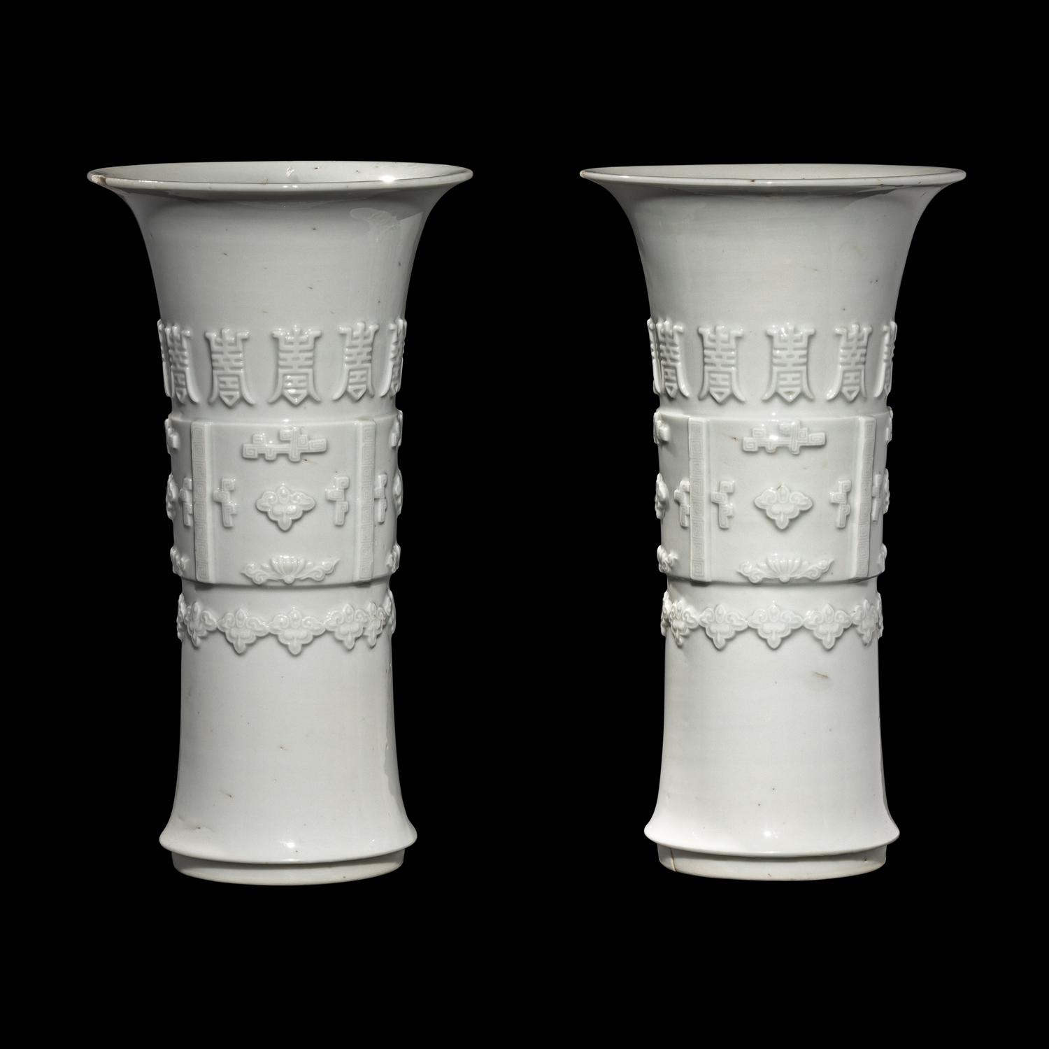 A Pair of Chinese Blanc-de-Chine Porcelain Gu Vases, Qing Dynasty 清 德化白瓷貼塑萬壽 如意花觚 一對