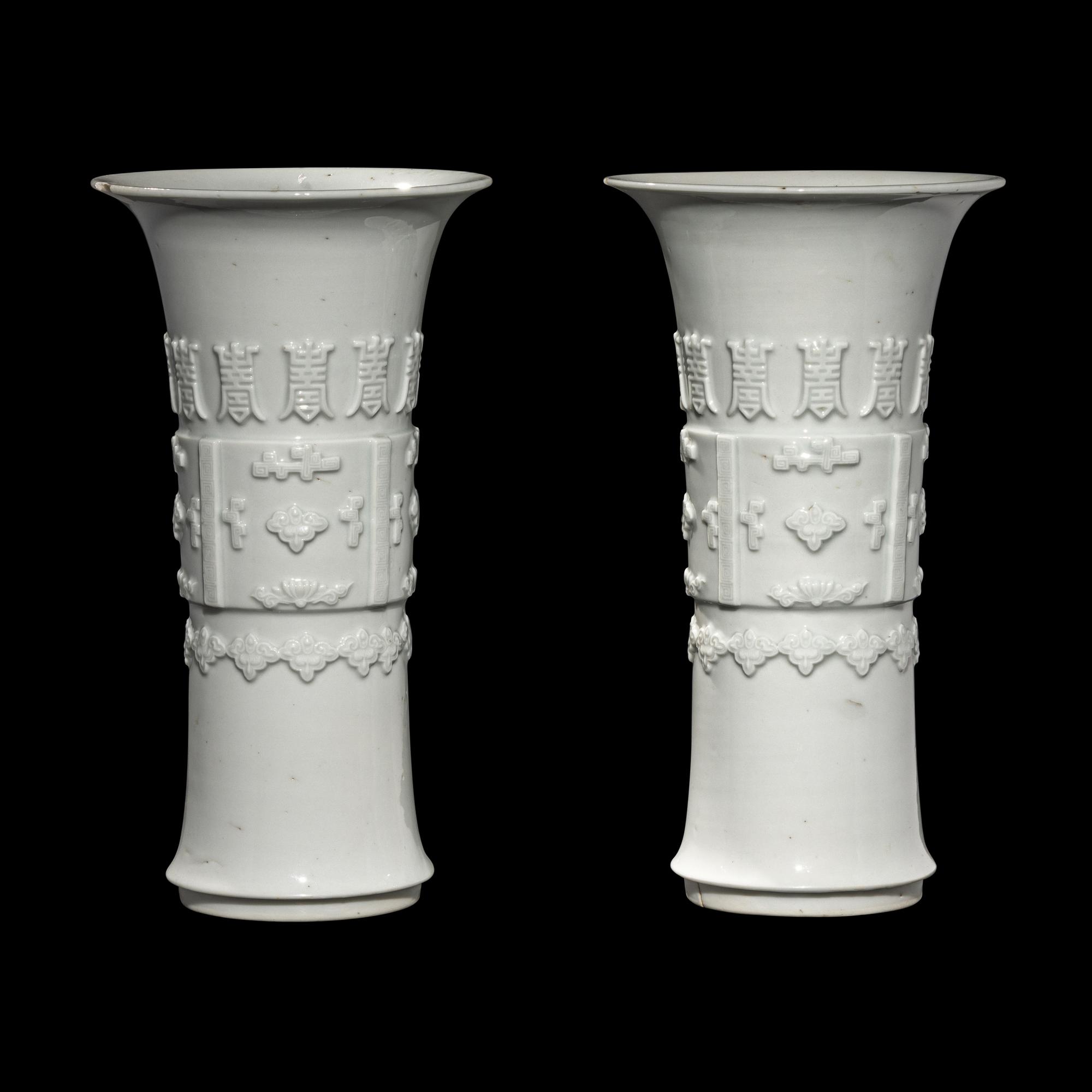 A Pair of Chinese Blanc-de-Chine Porcelain Gu Vases, Qing Dynasty 清 德化白瓷貼塑萬壽 如意花觚 一對