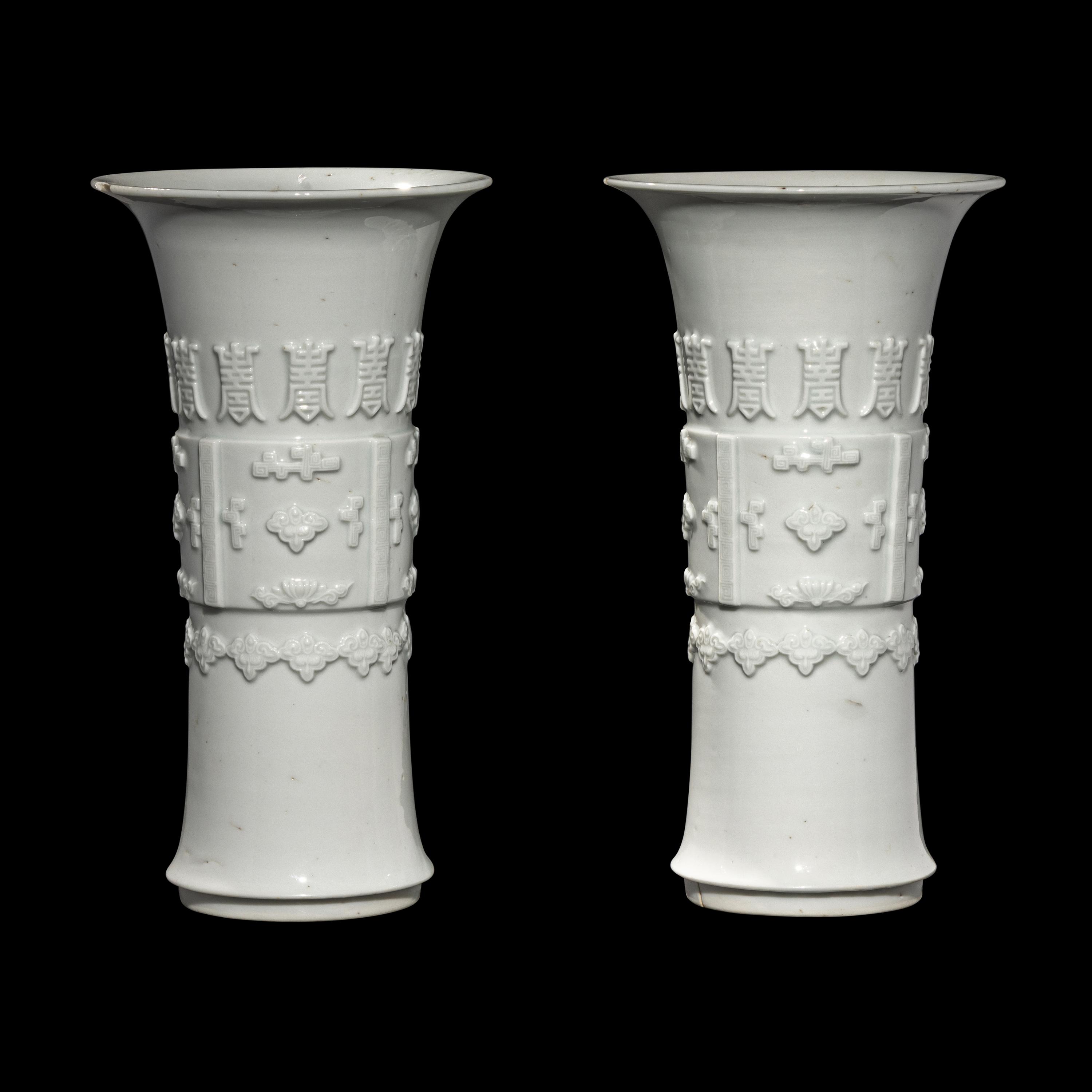 A Pair of Chinese Blanc-de-Chine Porcelain Gu Vases, Qing Dynasty 清 德化白瓷貼塑萬壽 如意花觚 一對