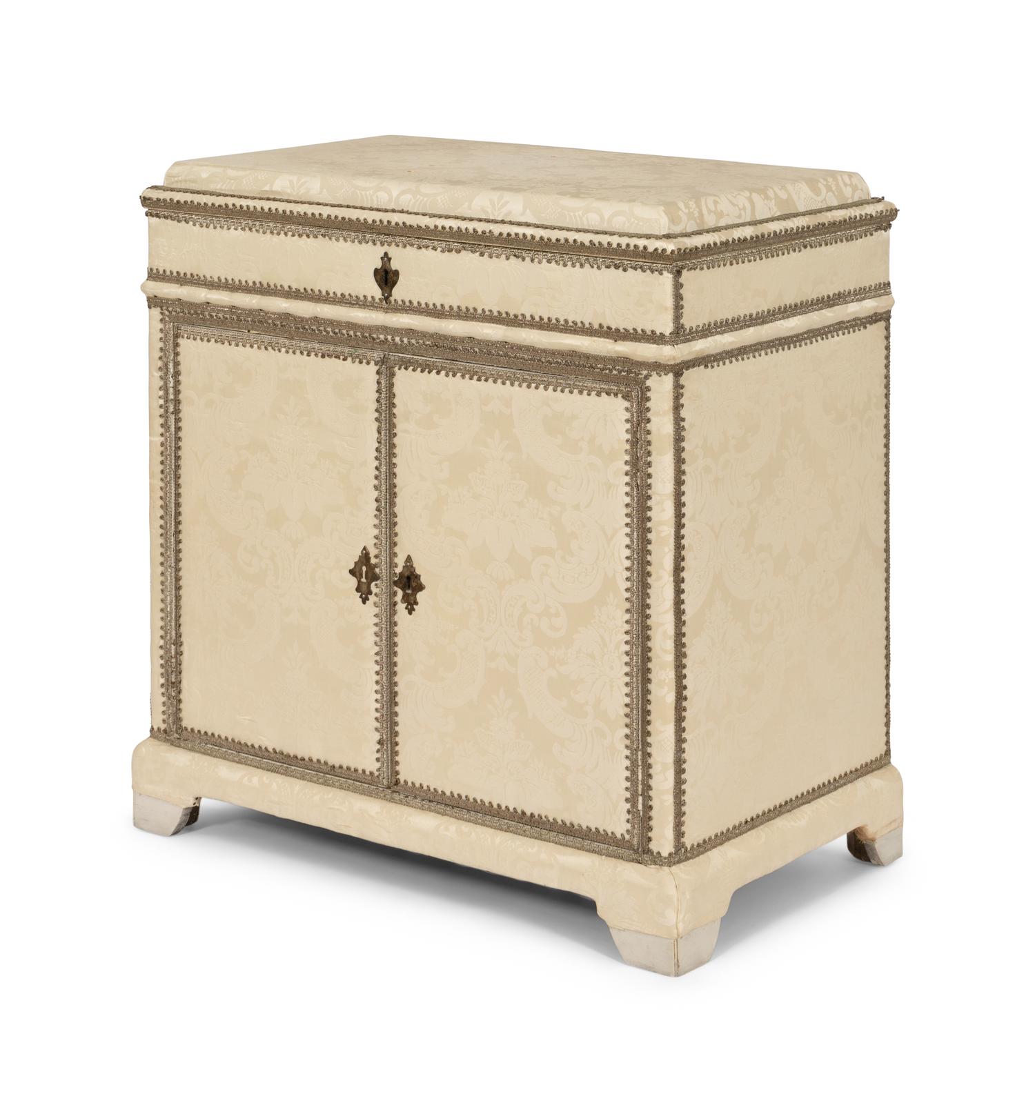 A Cream Damask-Upholstered And Painted Lift-Top Cabinet