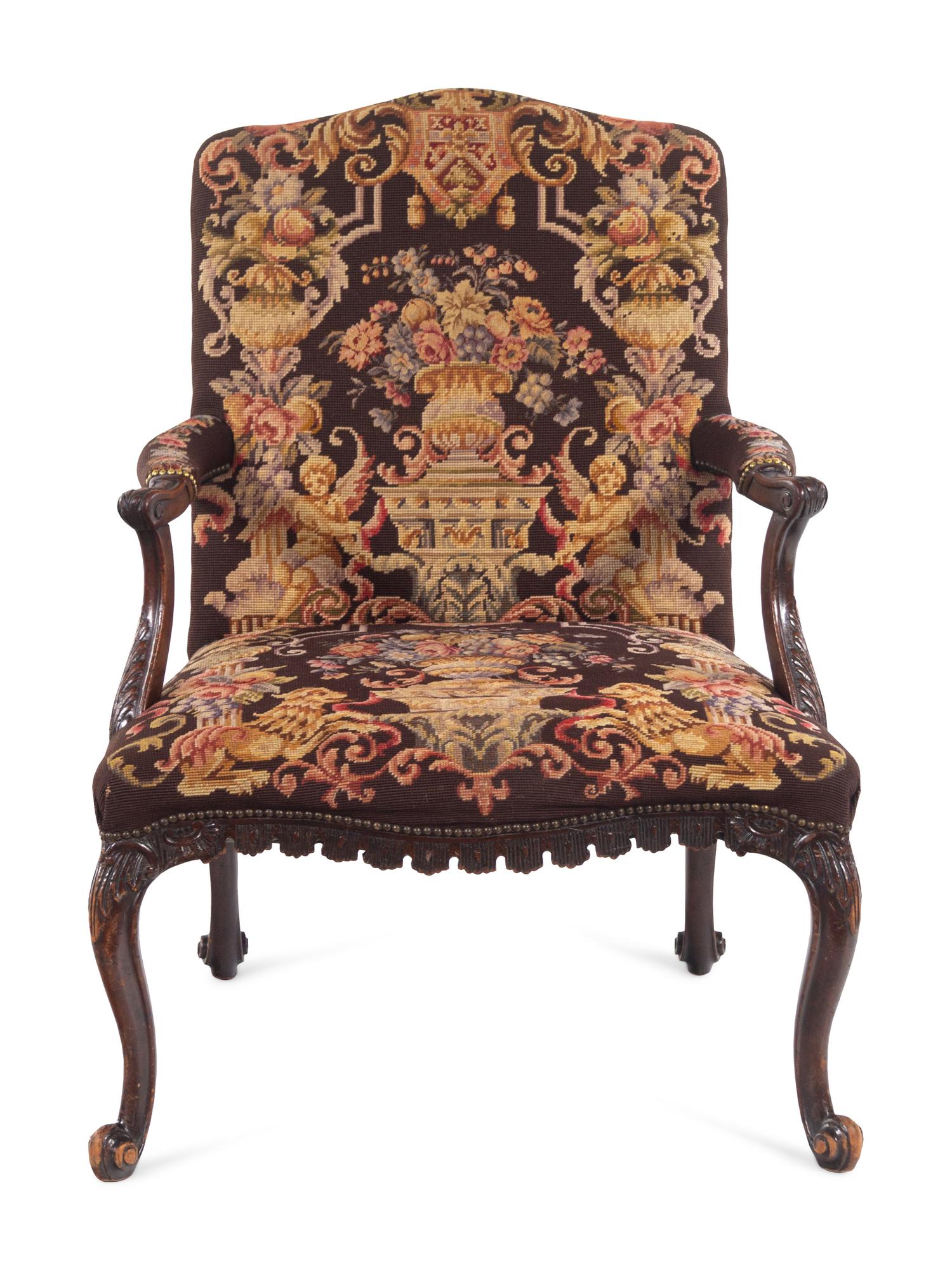 A George II Style Carved Mahogany Armchair with Needlepoint Upholstery
