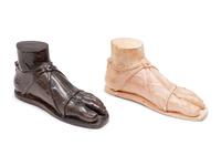 A Pair of Composition and Bronze Paw and Foot Form Doorstops