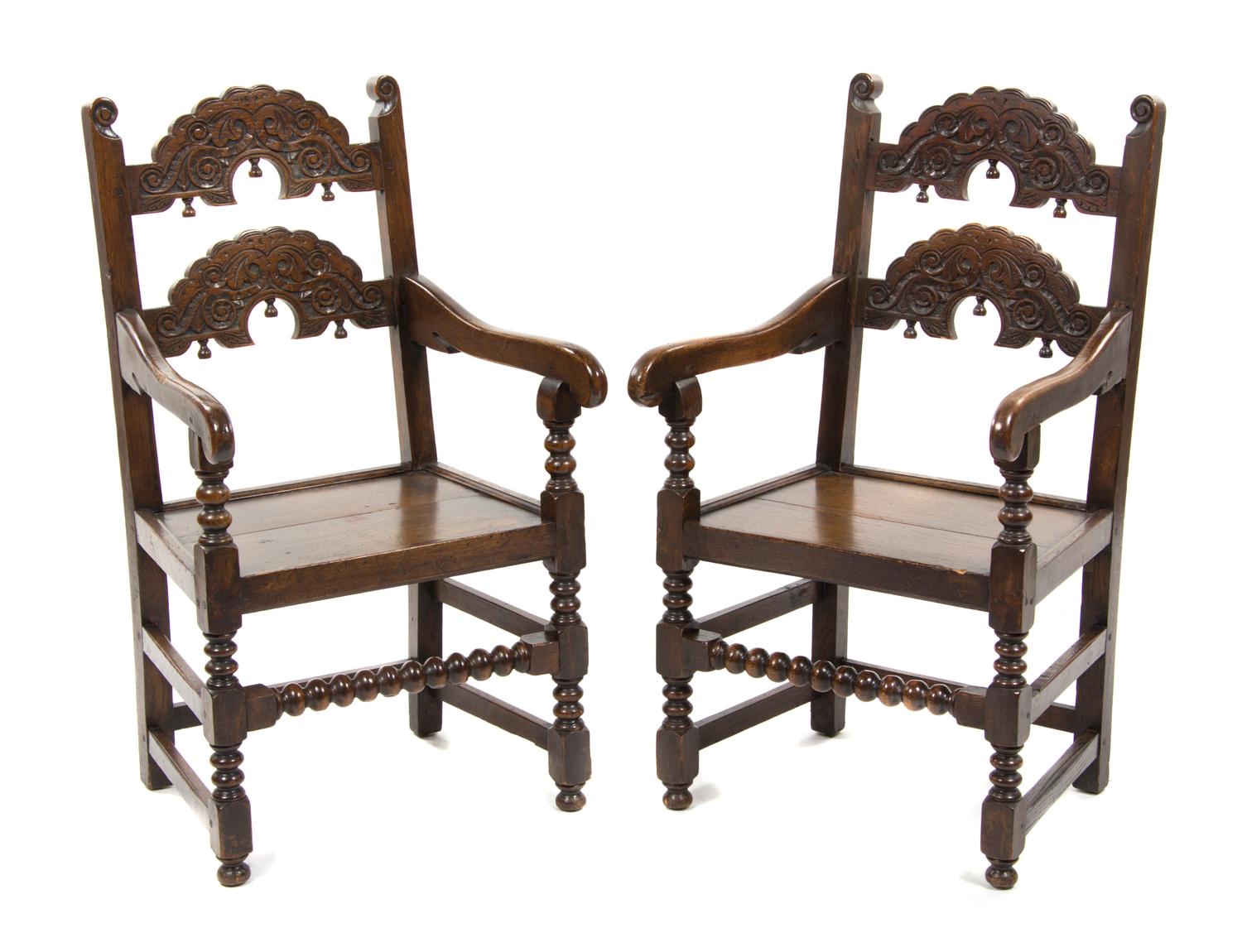 A Pair of Jacobean Revival Carved Oak Open Armchairs, Height 41 inches.