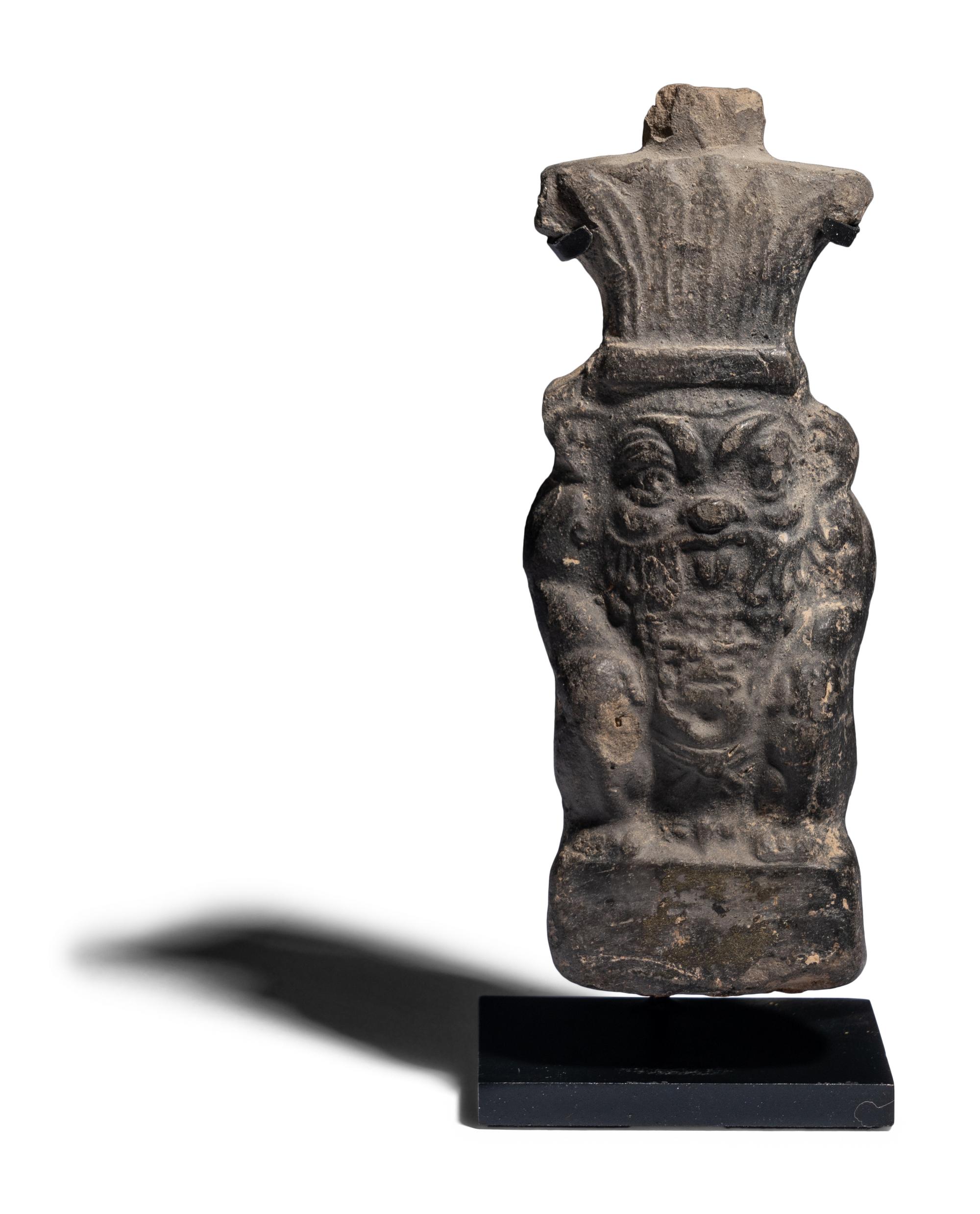 An Egyptian Terracotta Vessel in the form of Bes