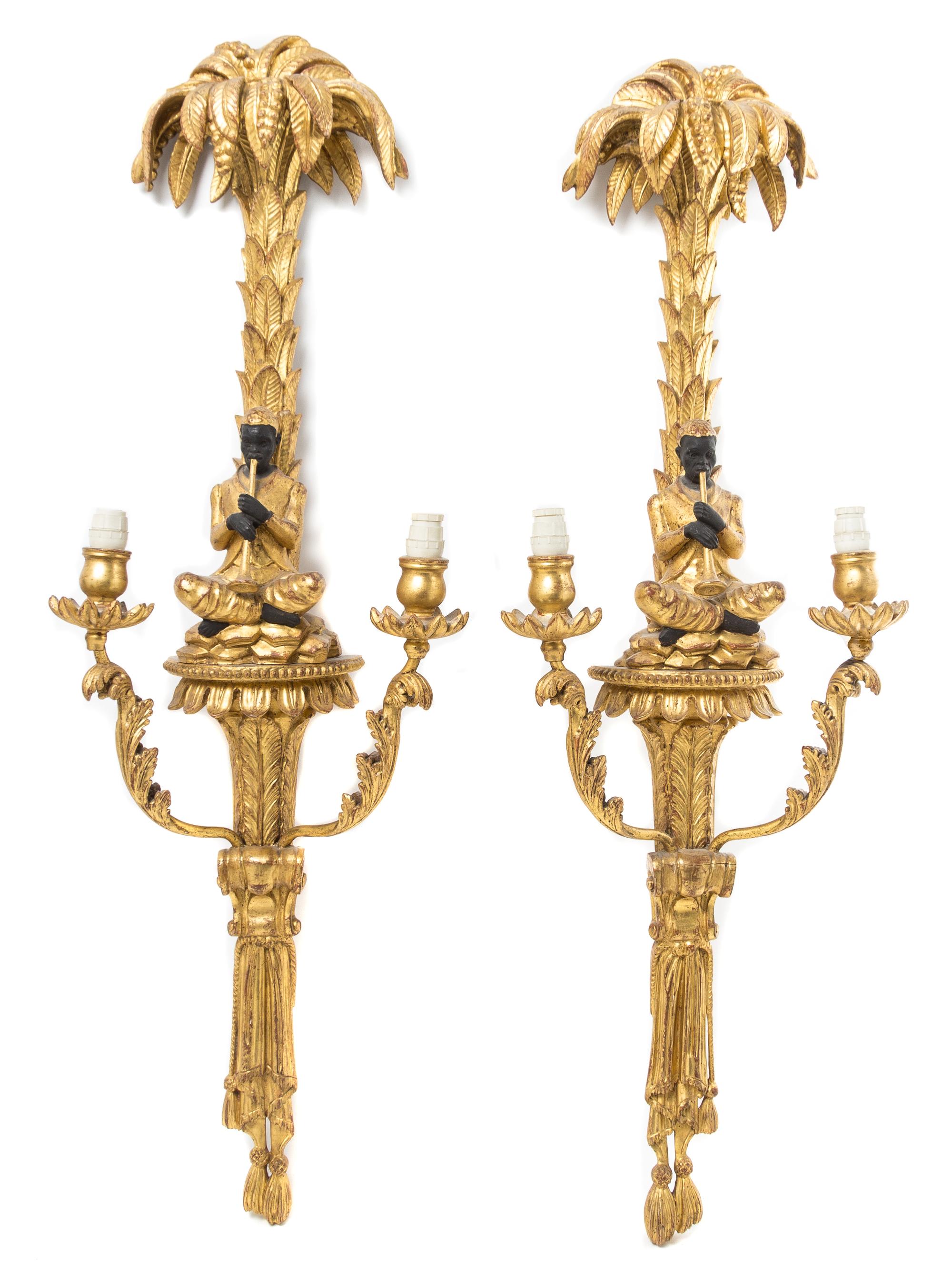 A Pair of Continental Parcel Ebonized Giltwood Two-Light Sconces Height 33 inches. — 20TH CENTURY