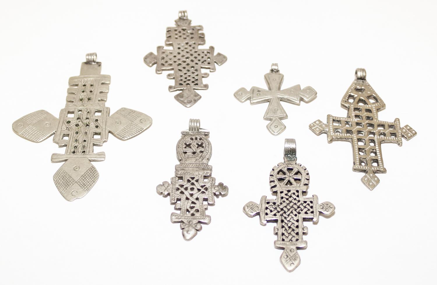 A Collection of Ethiopian Silver and Silvered Metal Cross Pendants Height of largest 4 inches.