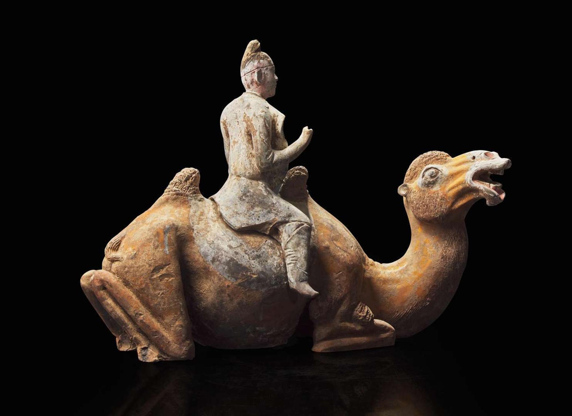 A Chinese painted pottery figure of a camel and rider, Tang dynasty 彩陶駱駝人俑 唐