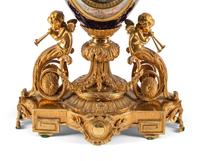 A French Gilt Bronze and Sèvres Style Porcelain Clock Garniture