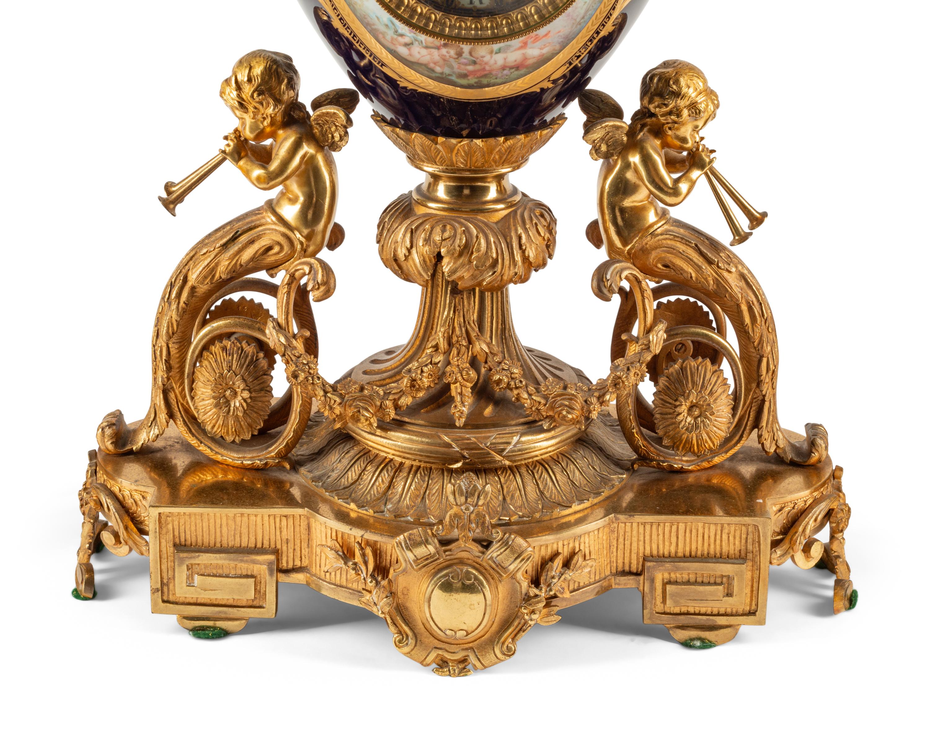 A French Gilt Bronze and Sèvres Style Porcelain Clock Garniture