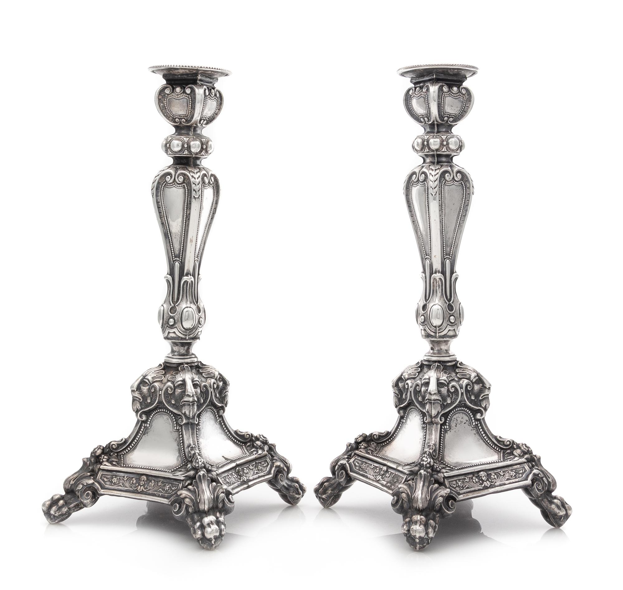 A Pair of Austrian Silver Candlesticks, Maker's Mark HS, Vienna, 19th Century, each stem of paneled baluster form with foliate and geom